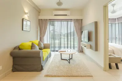 a living room with a couch and a bed at Meru Suites at Meru Valley Resort in Ipoh