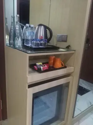 a kitchen with a tea kettle on top of a fireplace at Purest Hotel Sungai Petani in Sungai Petani