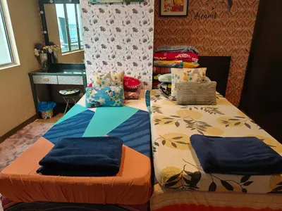 two beds sitting next to each other in a room at The Mons inside Tower Regency Hotel and Apartments in Ipoh
