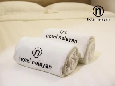 two towels sitting on top of a bed at Hotel Nelayan in Pangkor