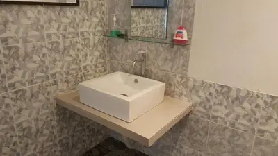 a bathroom with a white sink on a counter at Kurau Inn Boutique Farmstay in Kuala Kurau