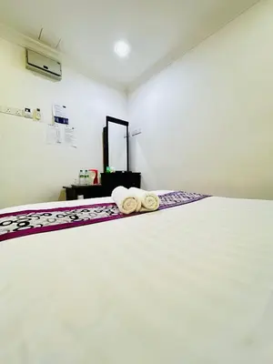 a bedroom with a bed with towels on it at Hotel Sagittario in Ipoh