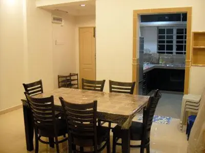 a dining room with a table and chairs at Lacy's Crown Imperial Court Apartment in Cameron Highlands