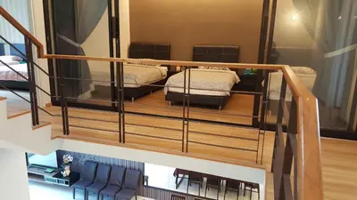 two beds on a wooden platform in a room at Shamrock Villas Corner OR Seaview OR Standard in Batu Ferringhi