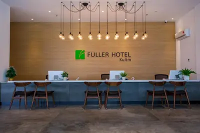 a lobby of a hotel with a table and stools at Fuller Hotel Kulim in Kulim