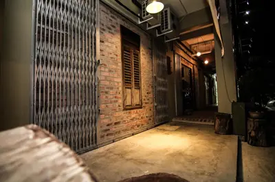 an empty hallway with a brick wall and a door at Rock Wood Hotel in Sungai Petani