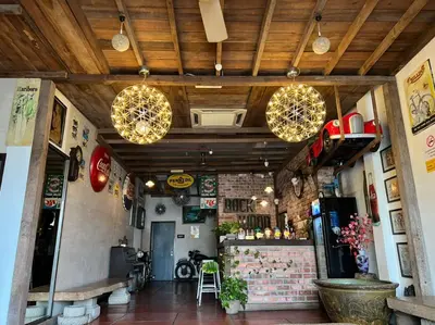 a restaurant with lights hanging from the ceiling at Rock Wood Hotel in Sungai Petani
