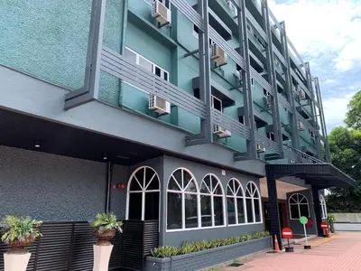 a building with potted plants in front of it at Hotel Waterfall in George Town