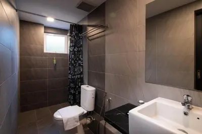 a bathroom with a toilet and a sink at Hotel Waterfall in George Town
