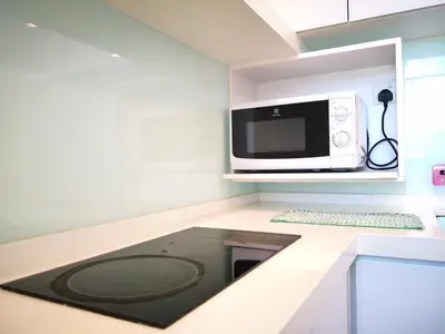 a kitchen with a microwave and a counter with a sink at Penang Studio Suite in Georgetown in George Town