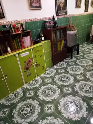 a room with a green and white tile floor at Farzai Homestay in Lumut