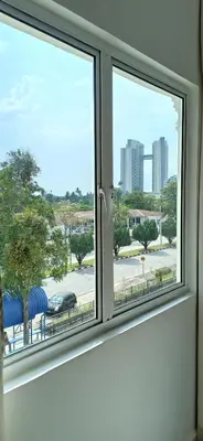 a window with a view of a city street at Hotel Alpha in Bukit Mertajam