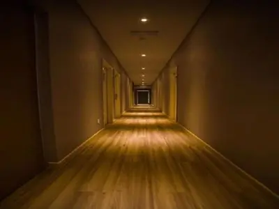 an empty hallway with a wood floor and a long corridor at Hollywood Hotel in Ipoh