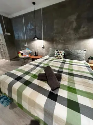 a bedroom with a large green and white bed at YY Residences in Ipoh
