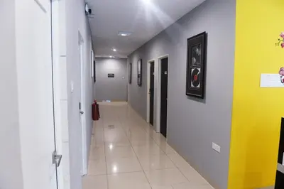 a hallway in a hospital with yellow and grey walls at Brezza Hotel Sitiawan in Sitiawan