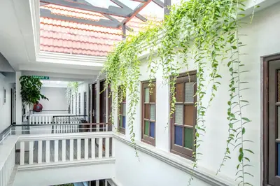 a balcony with ivy on the side of a building at Areca Hotel Penang in George Town