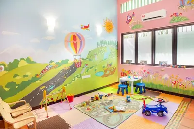 a childs room with a painting of a road and balloon at Areca Hotel Penang in George Town