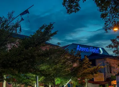 a sign for aacoco hotel on a building at night at Areca Hotel Penang in George Town