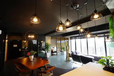 a living room with a table and chairs and lights at Manhattan Hotel Ipoh in Ipoh