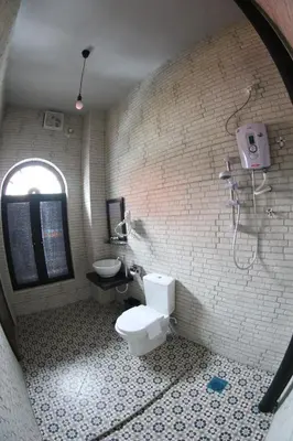 a bathroom with a toilet and a shower in it at JQ Ban Loong Boutique Hotel in Ipoh