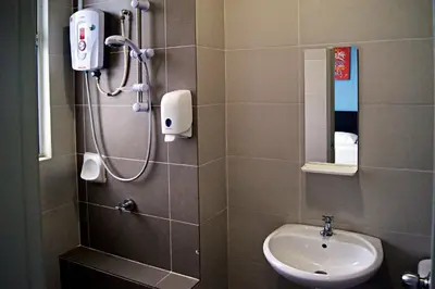 a bathroom with a shower and a sink at Play Residence at Golden Hills in Cameron Highlands
