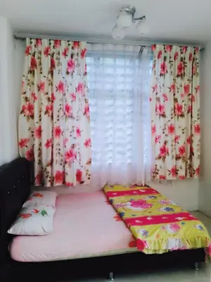 a bed in a room with curtains and a window at SA Apartments @ Crown Imperial Court in Cameron Highlands