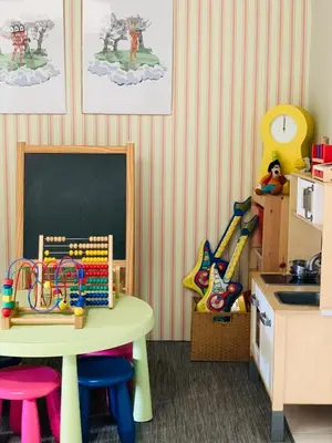 a childs play room with a table and a chalkboard at D'Houzz in Sungai Petani