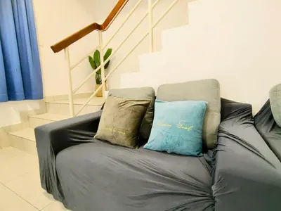 a black leather couch with two pillows on it at MY SWEETHUB HOMESTAY @ CAMERON HIGHLANDS in Cameron Highlands