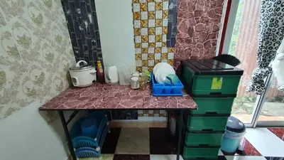 a table in a room with a counter top at Chalet Kampong Semawar in Kuala Kangsar