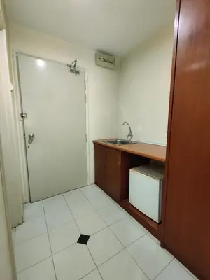 a small bathroom with a sink and a door at Wawa's Golf View Inn in Taiping