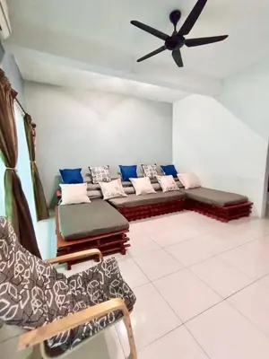 a living room with a couch and a ceiling fan at Ipoh Meru Animation Homestay by Grab A Stay in Ipoh