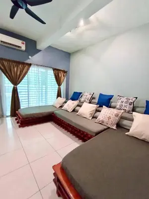 a bedroom with two beds and a ceiling fan at Ipoh Meru Animation Homestay by Grab A Stay in Ipoh