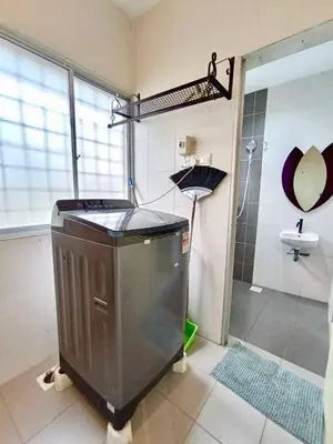 a bathroom with a shower and an umbrella at Ipoh Meru Animation Homestay by Grab A Stay in Ipoh