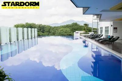 a pool with a reflection of the sky in the water at Ipoh City Center Stardorm Ipoh Homestay in Ipoh