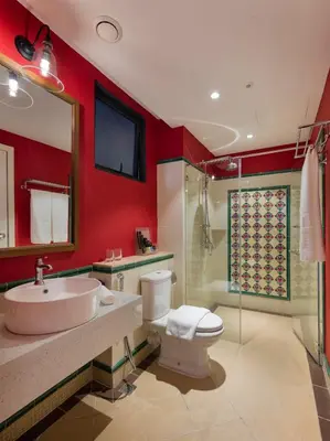 a bathroom with a toilet and a sink and a shower at The Granite Luxury Hotel Penang in George Town