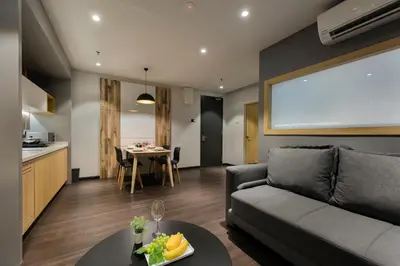 a living room with a couch and a table at The Granite Luxury Hotel Penang in George Town