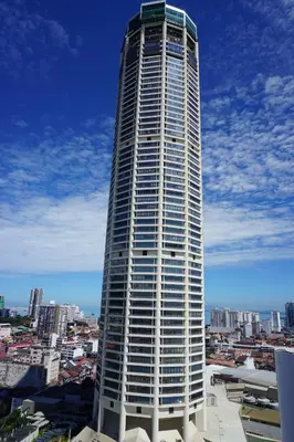 a tall white building with a city in the background at The Granite Luxury Hotel Penang in George Town