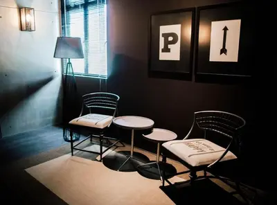a room with two chairs and a table and a lamp at M Boutique Kampar in Kampar