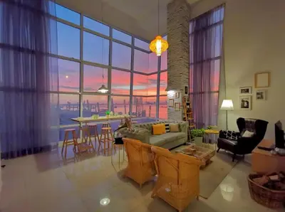a living room with a couch and a table with chairs at Maritime Suites Holiday Rental in George Town