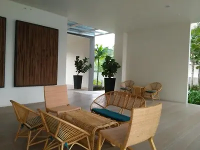 a living room with chairs and a table at By The Sea at Batu Ferringhi Penang in Batu Ferringhi