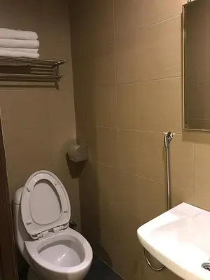 a bathroom with a toilet and a sink at Se One Hotel in Butterworth
