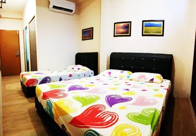 a room with two beds in a room at Lodge 163 Ventures in Ipoh