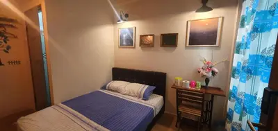 a small bedroom with a bed and a table at Lodge 163 Ventures in Ipoh