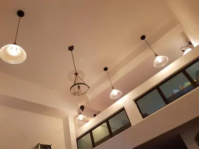 a room with five lights hanging from the ceiling at Lodge 163 Ventures in Ipoh