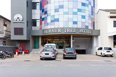 a group of cars parked in a parking lot in front of a building at Summer Tree Hotel Penang in George Town