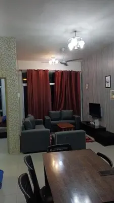 a living room with a table and chairs and a couch at Astana Barrington Square Goldenhills Pasar Malam Cameron Highlands in Cameron Highlands