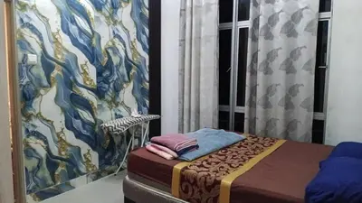 a room with a bed and a wall with a painting at Astana Barrington Square Goldenhills Pasar Malam Cameron Highlands in Cameron Highlands