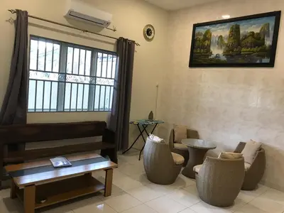 a living room with a couch and chairs and a window at 1248 Cozy Home in Ipoh