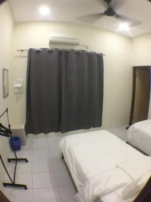 a bedroom with a bed and a black shower curtain at 1248 Cozy Home in Ipoh