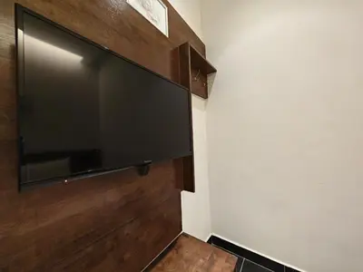 a flat screen tv hanging on a wall at Citrine Hotel in Seri Iskandar